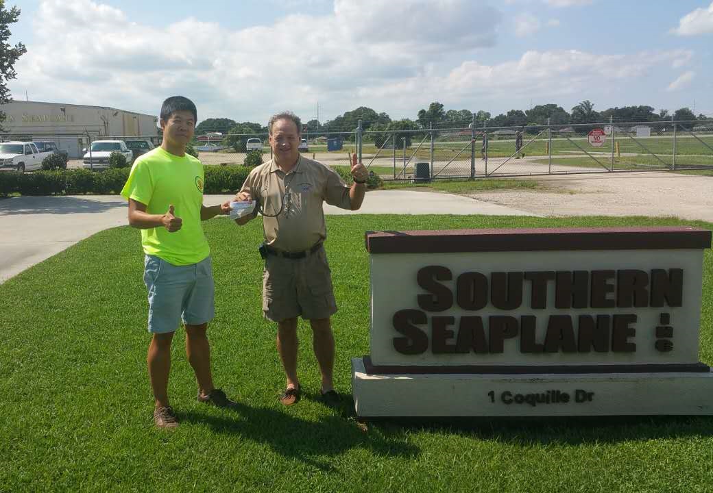 Picture of our student with his Examiner holding his new license.